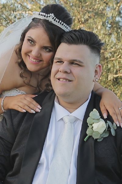 Felipe and Felicia smile for formal photos after their wedding